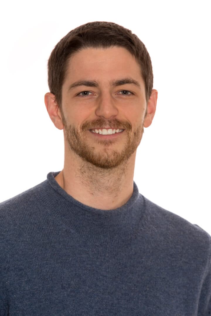 Jared Volle smiling in an outdoor headshot